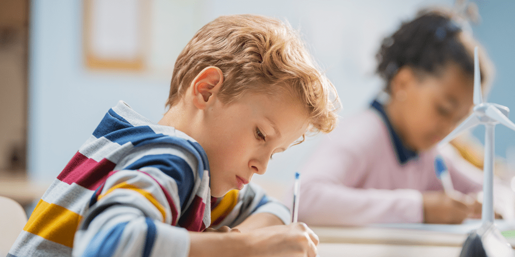 Students writing in a classroom.