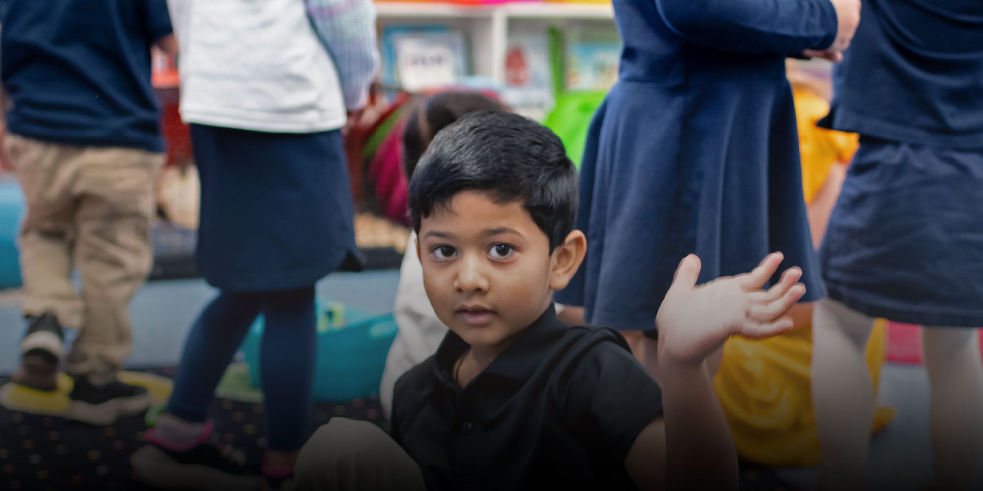 Elementary student waving